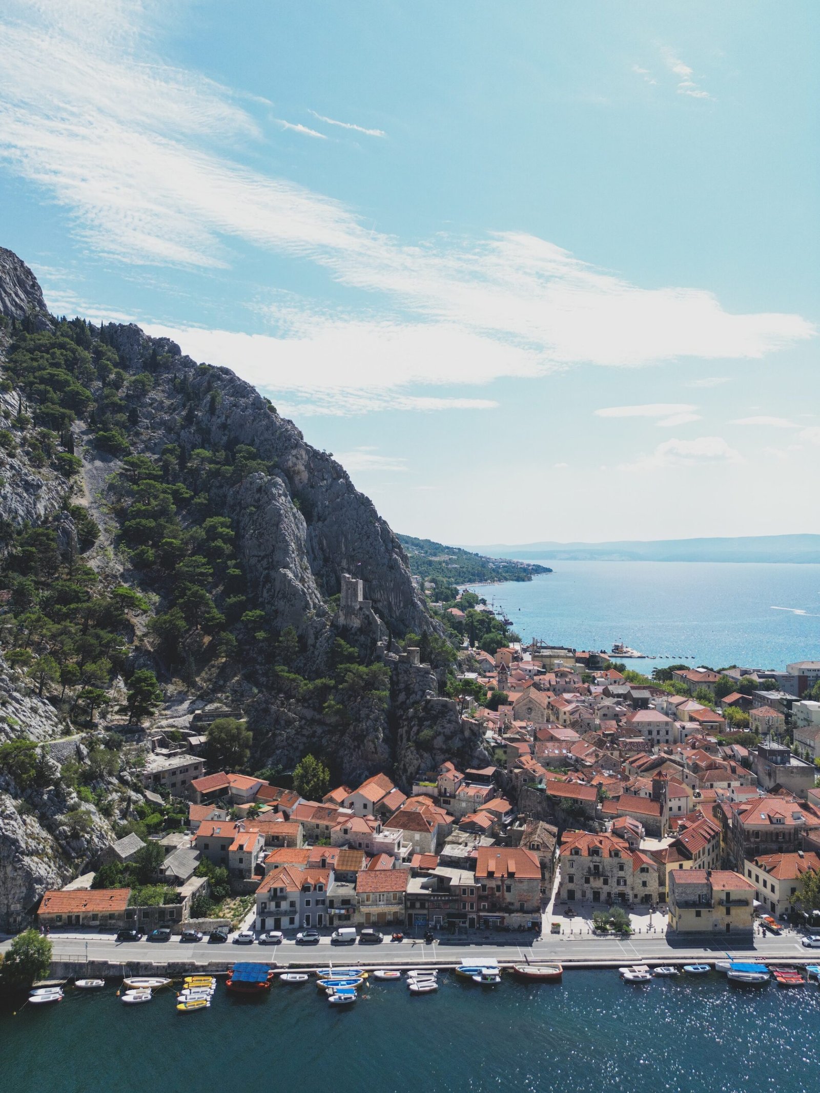 Walkers on a hiking tour in Dalmatia, Croatia, on a limestone path above the Adriatic